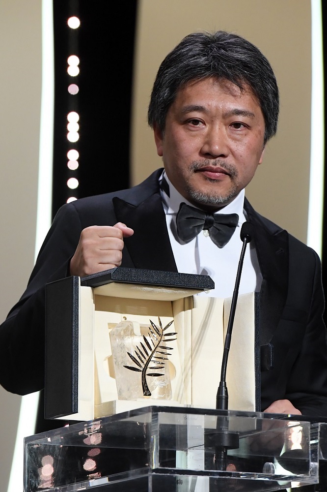 CANNES, FRANCE - MAY 19: Director Hirokazu Koreeda receives the Palme d'Or award for 'Shoplifters' (Manbiki Kazoku) on stage during the Closing Ceremony at the 71st annual Cannes Film Festival at Palais des Festivals on May 19, 2018 in Cannes, France. (Photo by Stephane Cardinale - Corbis/Corbis via Getty Images) *** Local Caption *** Hirokazu Koreeda